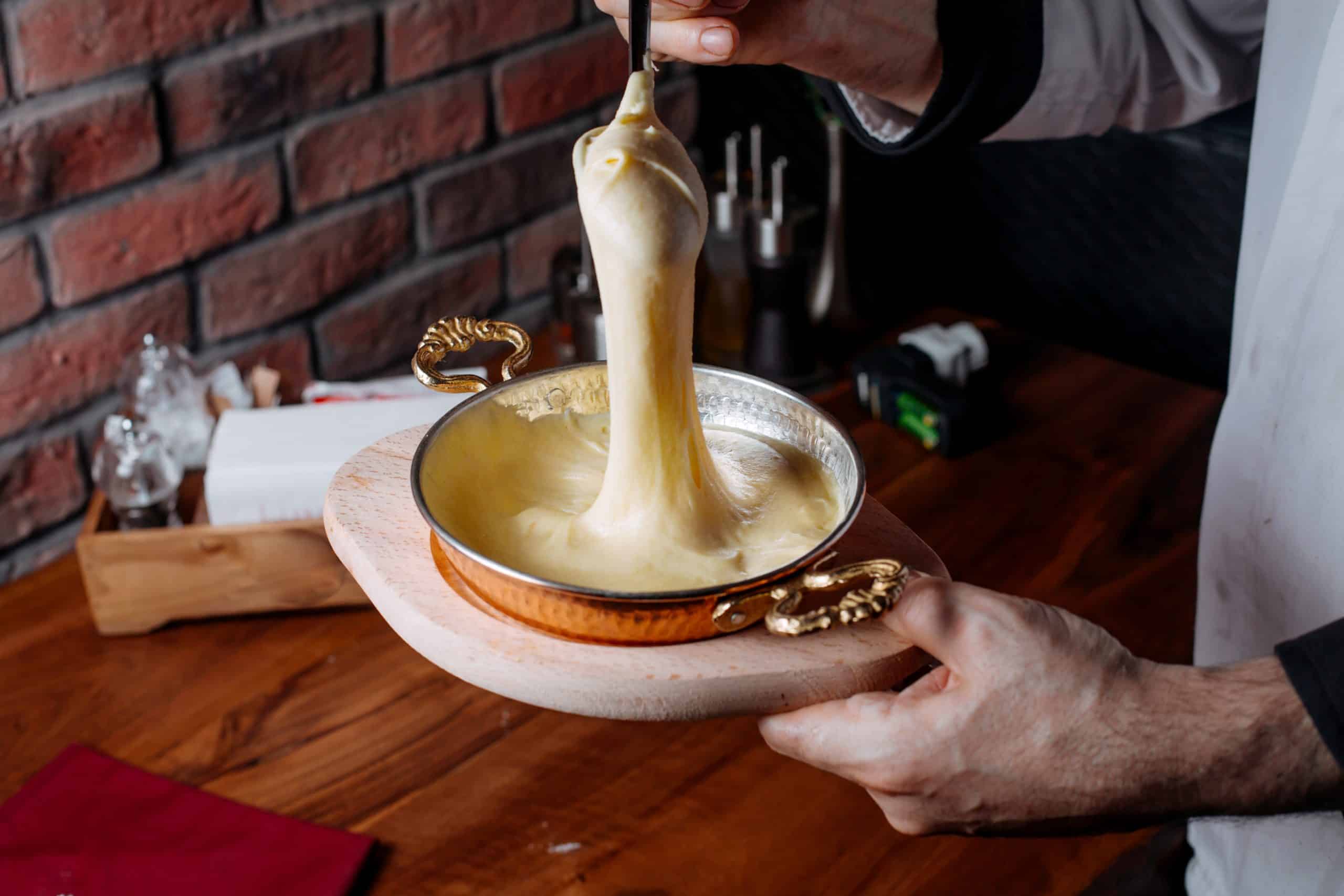 side view of pouring cake mixture into a baking tin